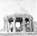 Man stands in front of ancient structure