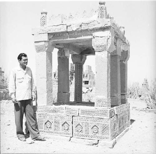 Man stands in front of ancient structure
