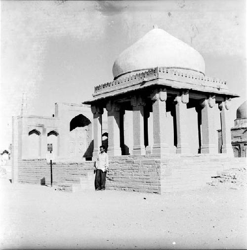 Man stands in front of ancient structure