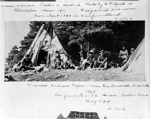 Men sit outside tents