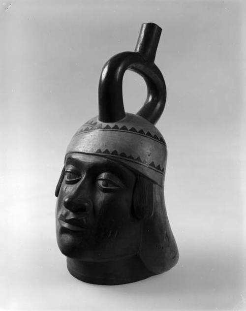 Stirrup pot in form of human head