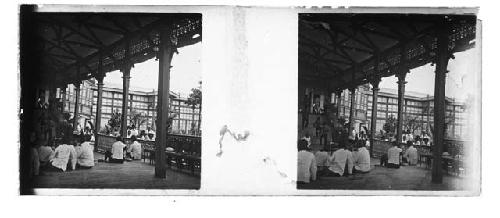 stereo glass slides of Siam; men seated on platform outdoors