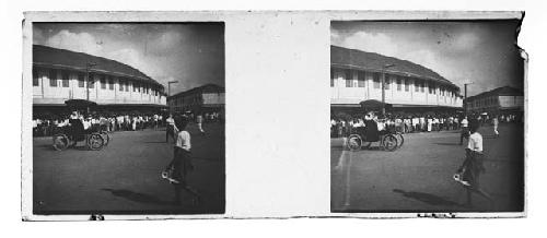 stereo glass plates of Siam; motorized buggy in street, building in background