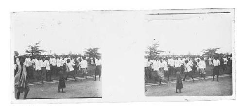 Stereo glass slides of Siam; men in white coats and boy mingling on side of road