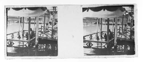 Stereo glass slides of Siam; men in ceremonial bath along dock