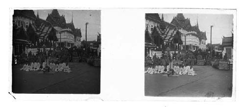 stereo glass slides of Siam; men  in white coats seated around shrine