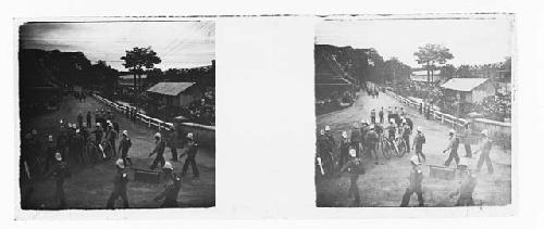 stereo glass slides; men with helmets and wagon on street