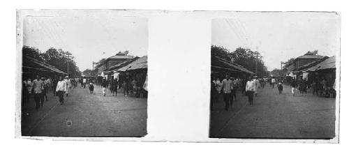 stereo glass slides; people strolling on street, railway tracks in center