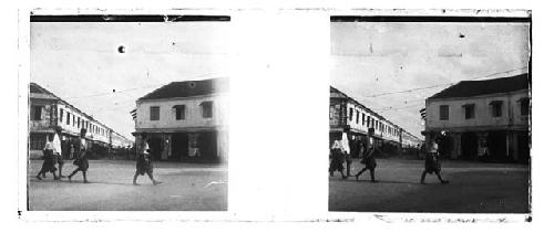 stereo glass slides; three people in traditional garb walking on street