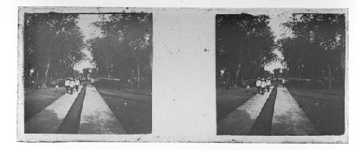 stereo glass slides; men in white jackets walking on footpath