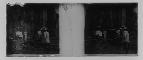 stereo glass slides; men in white uniforms standing among ruins