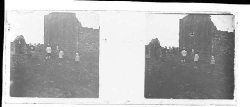 stereo glass slides; four men in white jackets/helmets looking at ruins