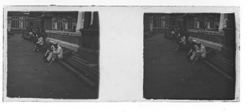 stereo glass slides; people sitting on street curb