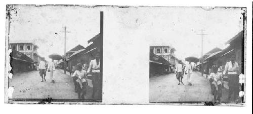 stereo glass slides; pedestrians, one holding umbrella