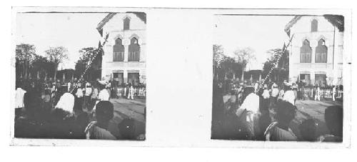 stereo glass slides; people gathered in town square, striped pole foreground