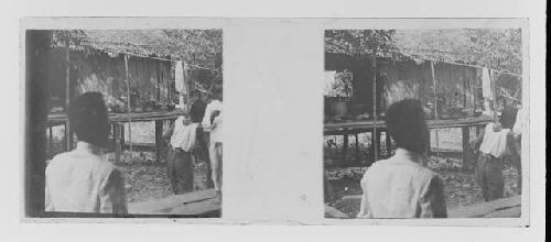stereo glass slides; hut on stilts, people in foreground