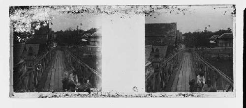 stereo glass slides; boardwalk, people in foreground, houses on left