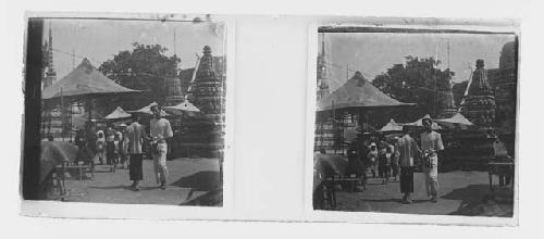 stereo glass slides; people walking on street, umbrellas in background