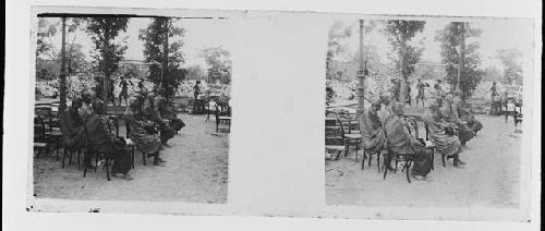 stereo glass slides; buddhists seated outdoors on chairs