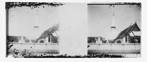 stereo glass slides; wall with rooftops and shrine in background