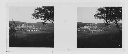 stereo glass slides; view of field, cliff and bridge in background