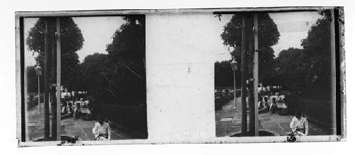 stereo glass slides; men sitting on street in white jackets