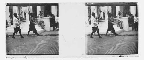 stereo glass slides; two men walking in a procession