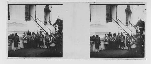 stereo glass slides; men in helmets gathered outside entryway