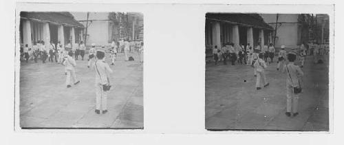 stereo glass slides; men in uniform walking on outdoor plaza