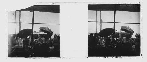 stereo glass slides;  BROKEN SLIDE men holding umbrellas overlooking festivities