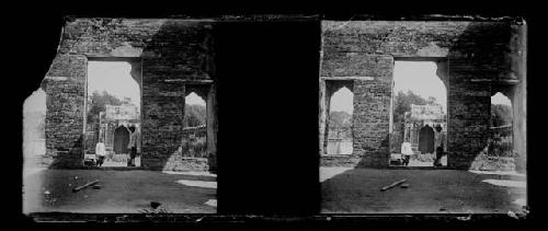 stereo glass slides; two people standing in doorway of ruins