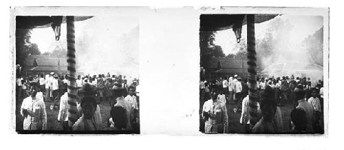 Stereo glass slides of Siam; people at village gathering, smoke in distance