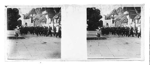 Stereo glass slides of Siam; soldiers marching in street, buildings background