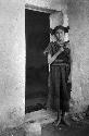 Hopi woman of Oraibi standing in doorway