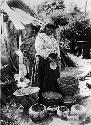 Old Curly. Died 1906. Shown with baskets.