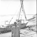 Man standing in front of a boat on Indus river at Pattan Ferry