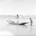 Men stand on and around boat on Indus river at Pattan Ferry