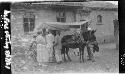 People standing at donkey-drawn carriage