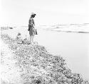 A man stands along a riverbank on Indus river at Pattan Ferry