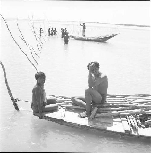 Two people sit on a boat on Indus river at Pattan Ferry