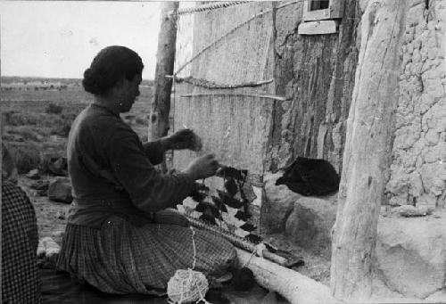 Reproduction of woman weaving on loom