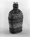 Basketry bottle; design of plain and zigzag horizontal lines