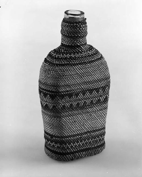 Basketry bottle; design of plain and zigzag horizontal lines