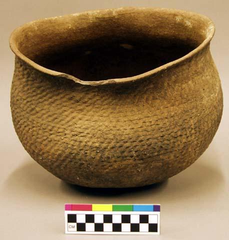 Irregular-shaped, flare-rimmed pot, corrugated.