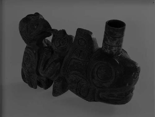 wooden pipe elaborately carved with animal and bird forms