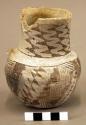 Jar, lug is missing, rim sherd missing, black on white geometric design on exter