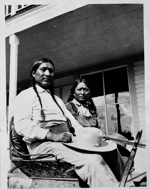 Two Indians seated on porch -- Ed Ladd, Jicarillo Apache; Santa Clare Pueblo Indian