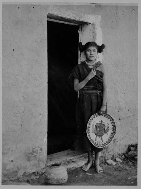 Hopi woman holding a Thunderbird Wicker Basket
