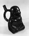 Stirrup pot (black), man sitting cross-legged