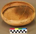 Ceramic bowl, brown on orange interior and exterior, round base, mended
